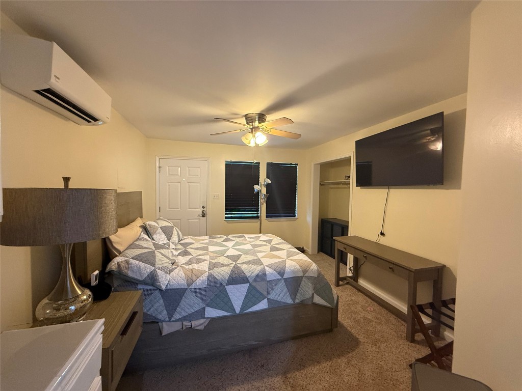 4413 Nixon Lane, Unit C Austin, TX 78725 - Photo 7 of 9 a bedroom with bed tv and table