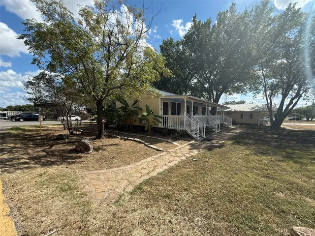a view of a house with snow on the road