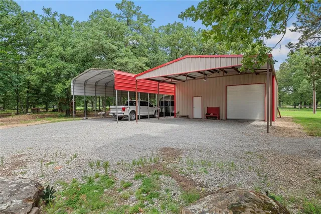 a view of patio with a table and chairs under an umbrella