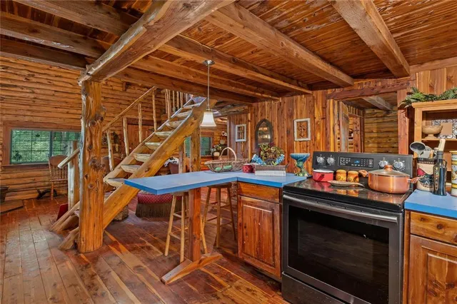 a view of a patio with table and chairs with wooden floor and fence