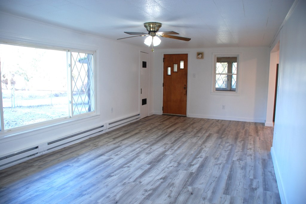 2242 Spruce Road Cherry Tree, PA 15724 - Photo 21 of 39 a view of an empty room with a window and wooden floor