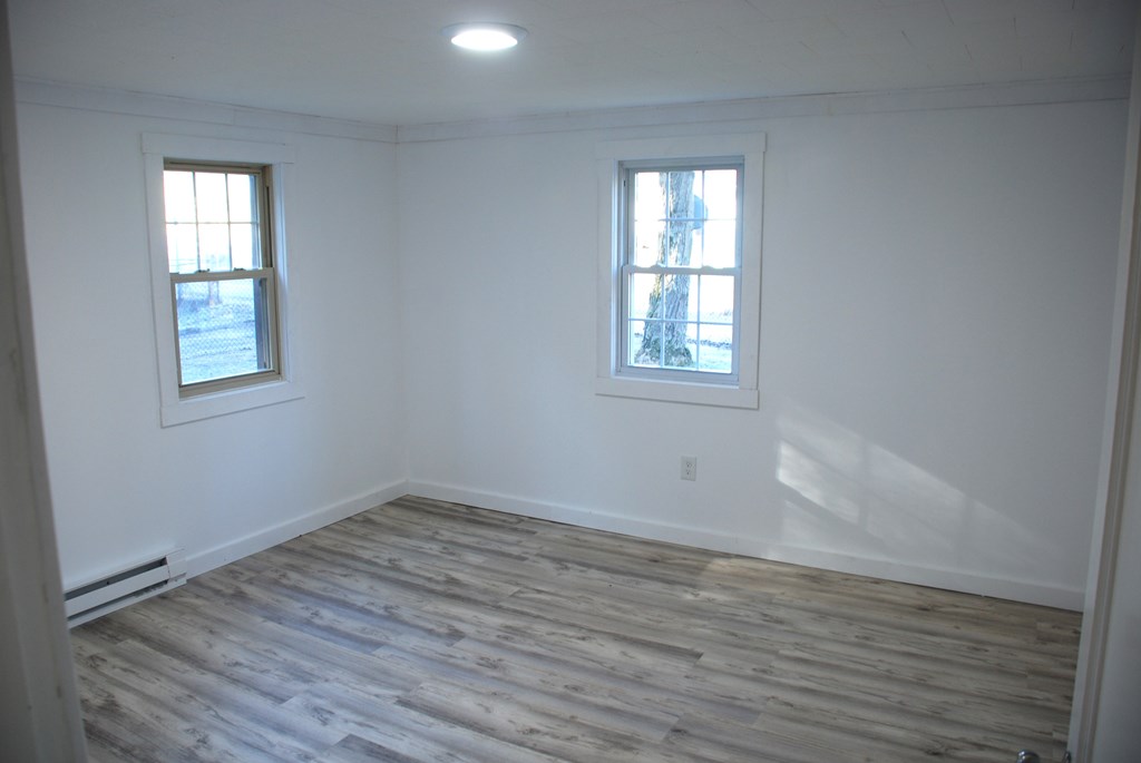 2242 Spruce Road Cherry Tree, PA 15724 - Photo 23 of 39 an empty room with wooden floor and windows