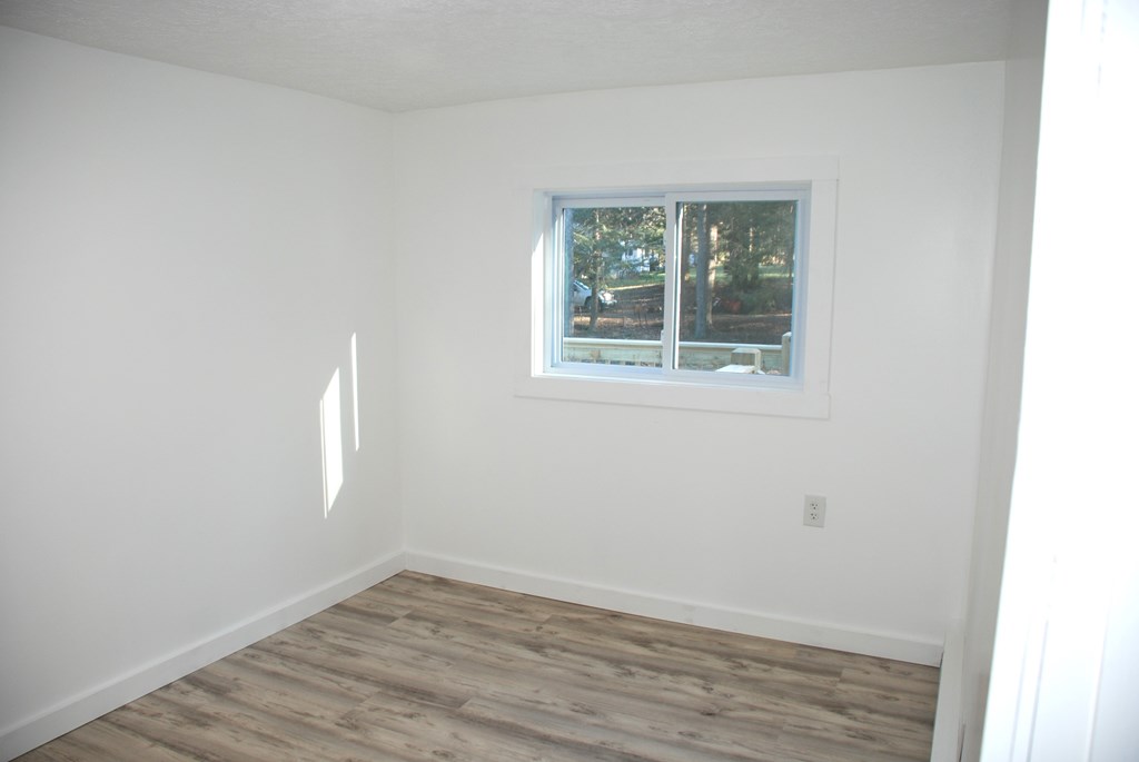 2242 Spruce Road Cherry Tree, PA 15724 - Photo 34 of 39 an empty room with wooden floor and windows