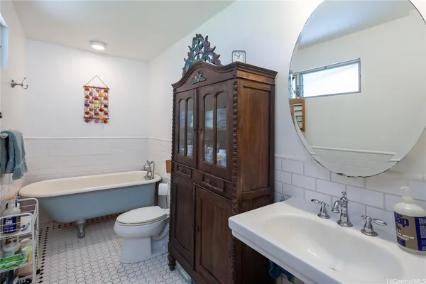 a bathroom with a sink a toilet and bathtub