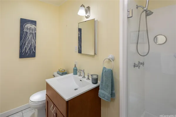 a bathroom with a sink a toilet and shower curtain