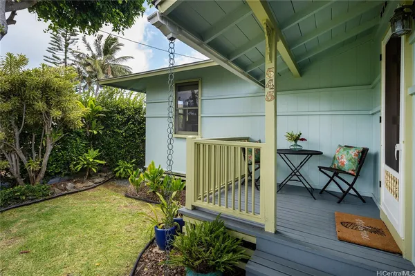 a view of a porch with furniture and garden