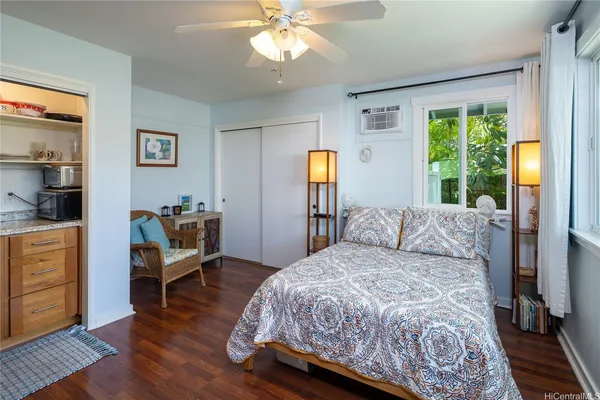 a bedroom with a bed and wooden floor