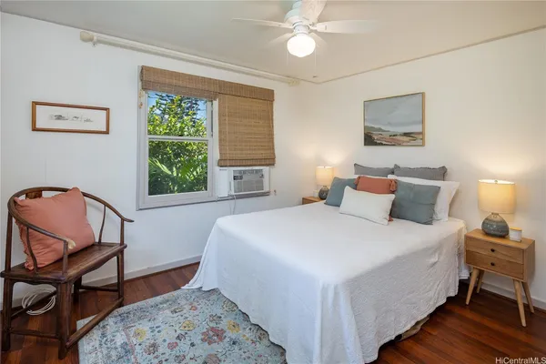 a bedroom with a bed a chair and a window