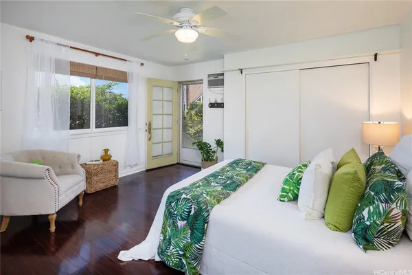 a living room with furniture and a potted plant