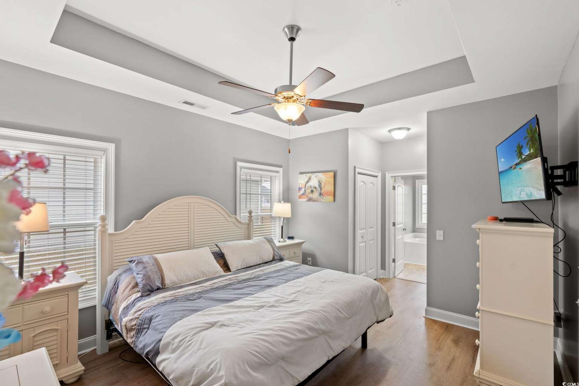286 Copperwood Loop Conway, SC 29526 - Photo 13 of 40 Bedroom with a tray ceiling, a closet, wood finished floors, and a ceiling fan