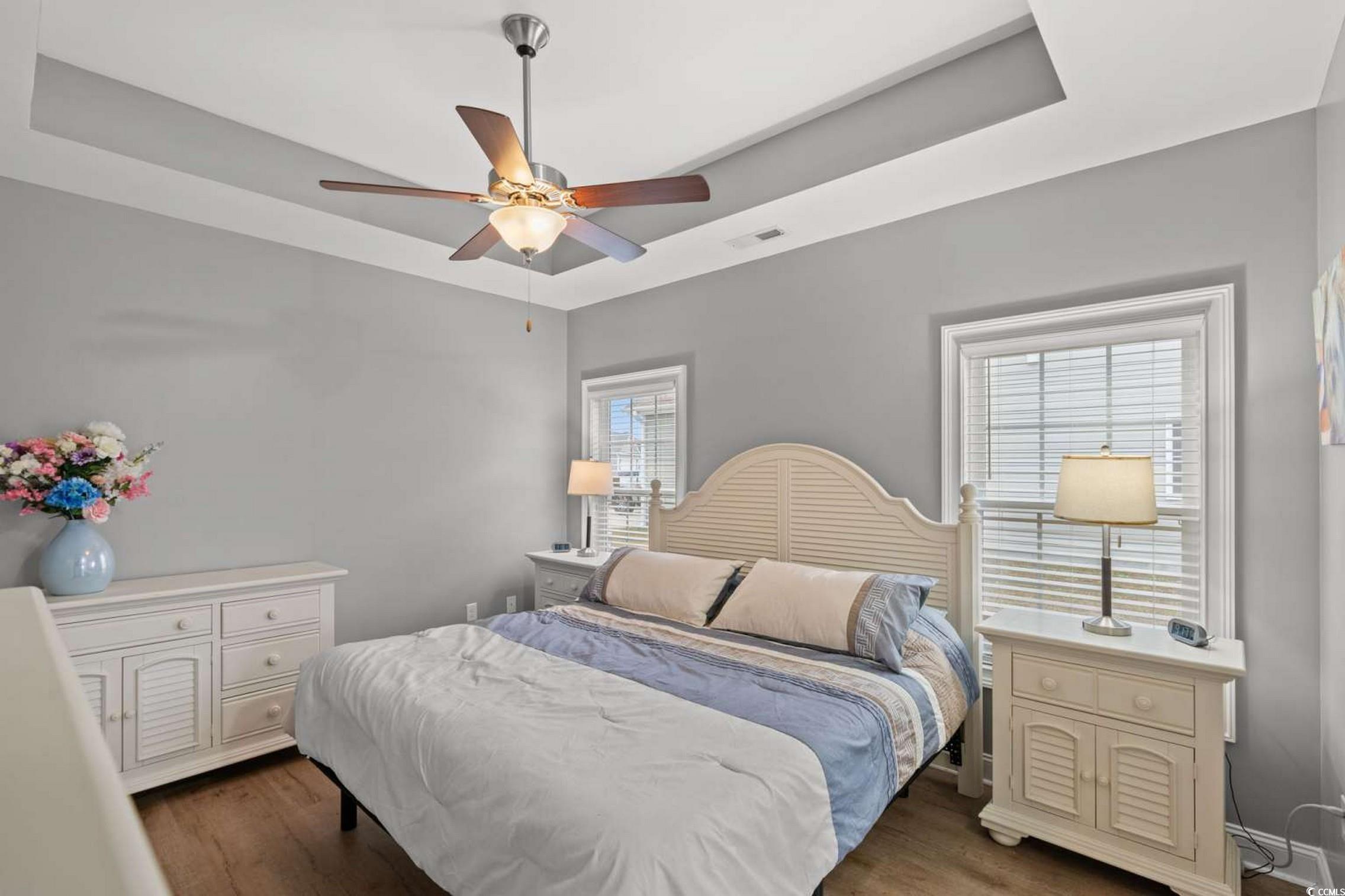 286 Copperwood Loop Conway, SC 29526 - Photo 15 of 40 Bedroom with a tray ceiling, dark wood-style flooring, and ceiling fan