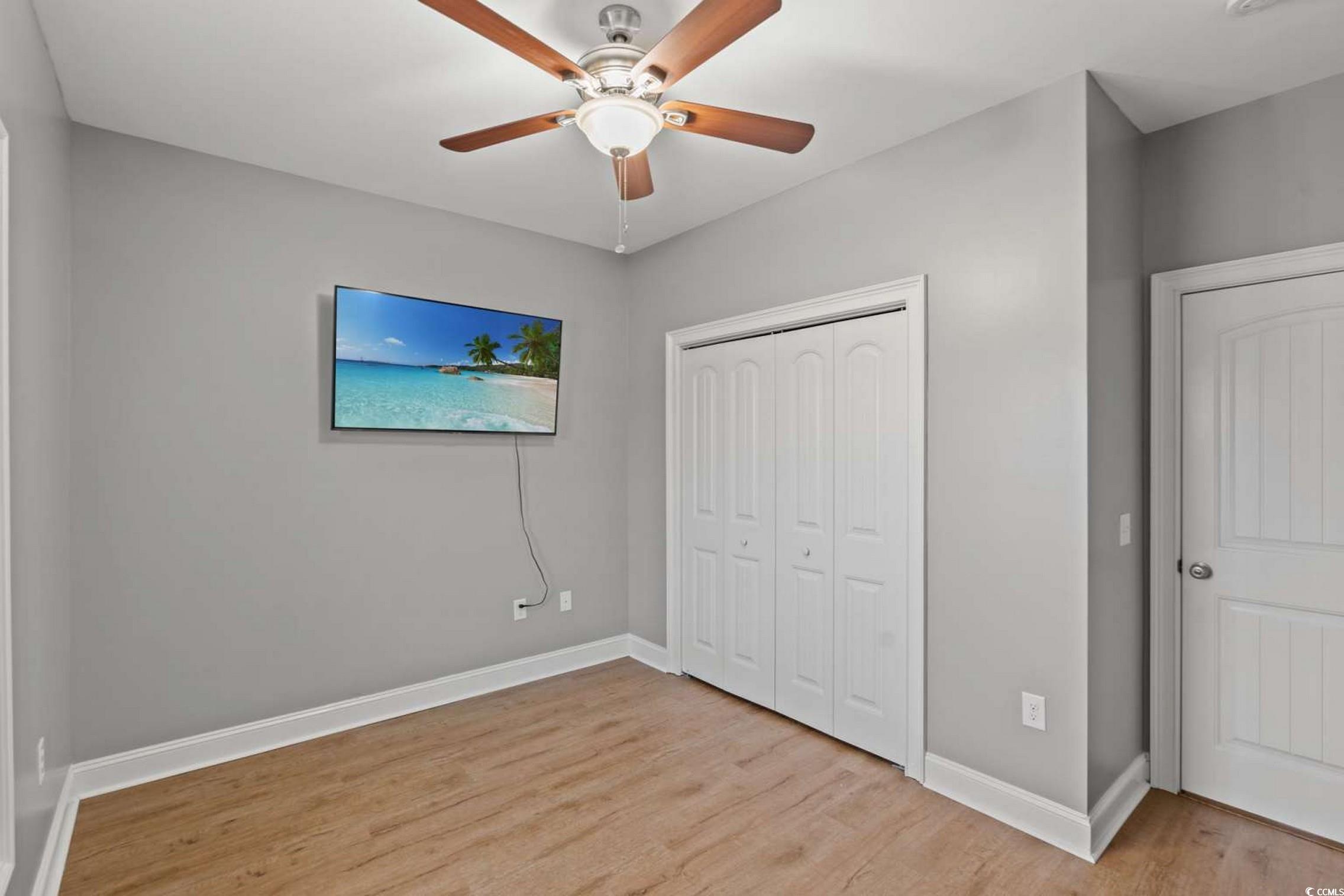 286 Copperwood Loop Conway, SC 29526 - Photo 19 of 40 Unfurnished bedroom with light wood-style flooring, a ceiling fan, and a closet