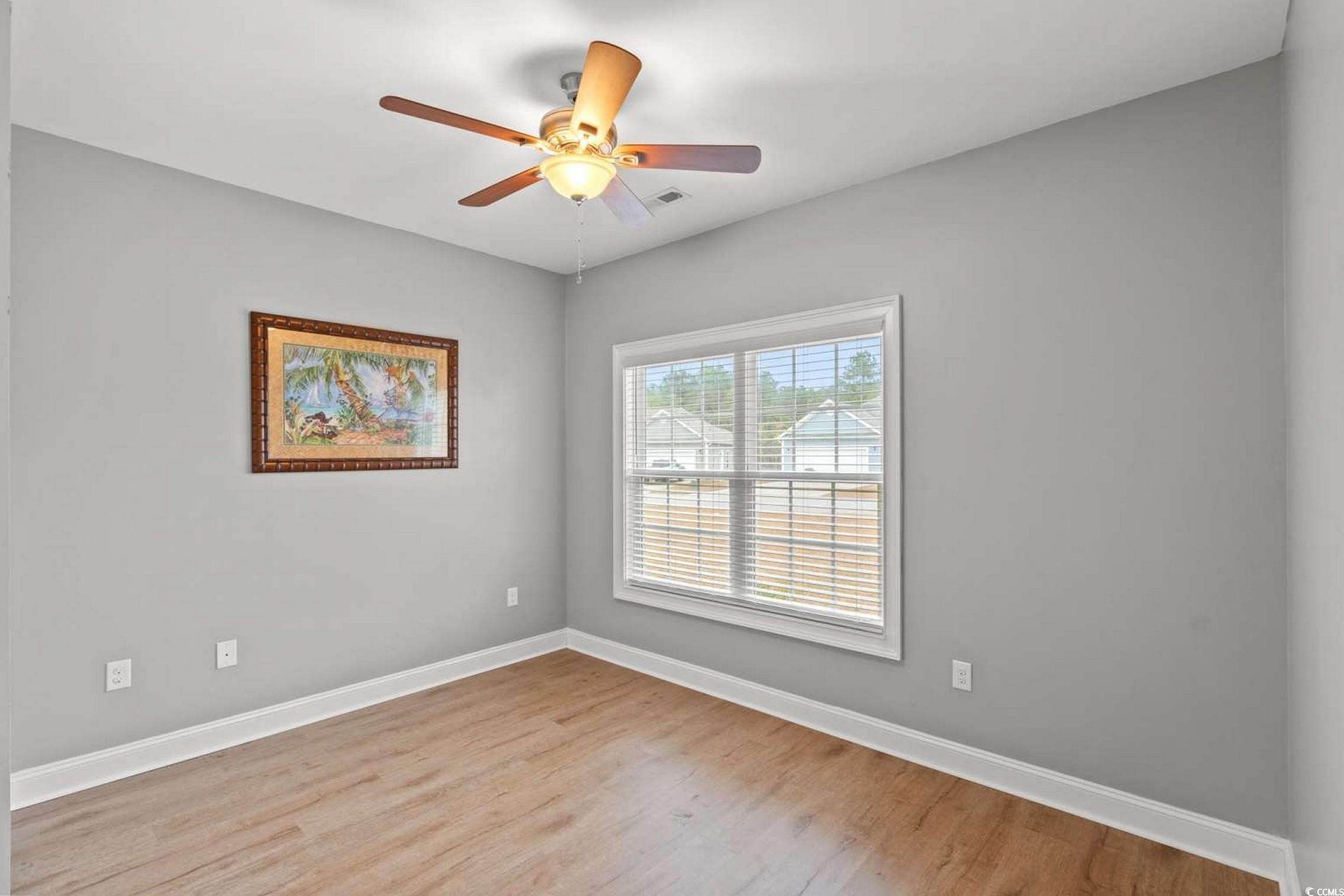 286 Copperwood Loop Conway, SC 29526 - Photo 21 of 40 Unfurnished room featuring light wood-style floors and a ceiling fan
