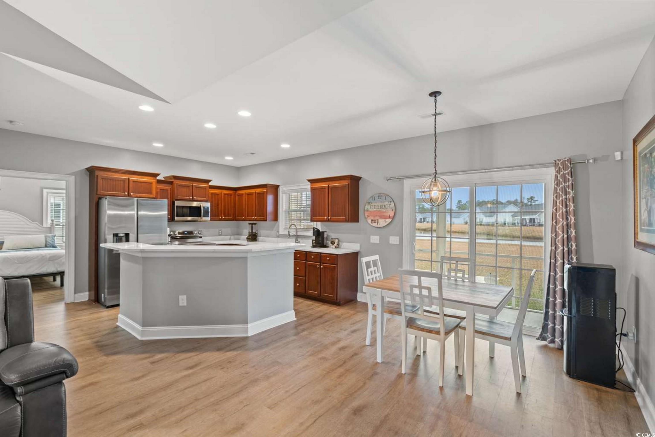286 Copperwood Loop Conway, SC 29526 - Photo 9 of 40 Kitchen featuring stainless steel appliances, brown cabinets, recessed lighting, a center island, and pendant lighting