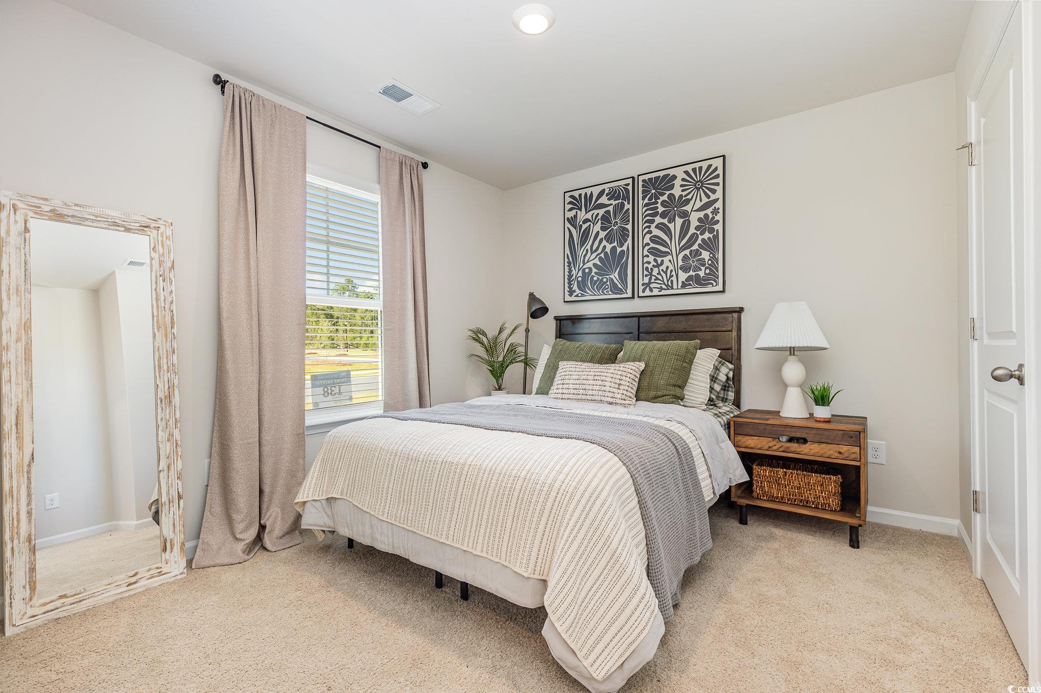 7382 Meadow Walk Loop Loris, SC 29569 - Photo 16 of 24 Bedroom featuring light colored carpet and baseboards