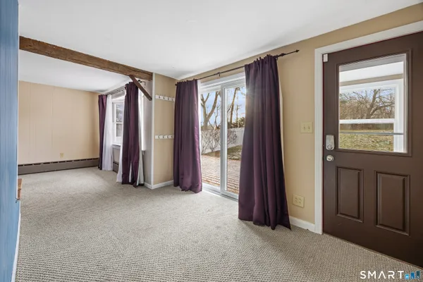 an empty room with windows and closet