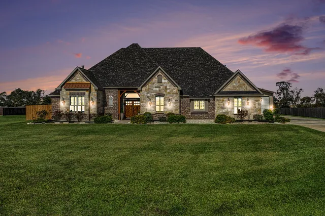 a front view of a house with a garden