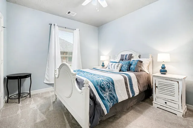 a bedroom with a bed and a table