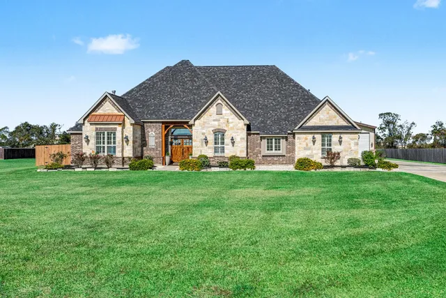 a front view of a house with a garden
