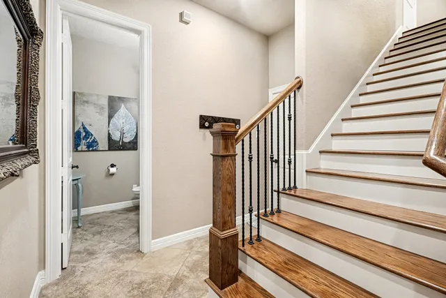 a view of a hallway with wooden floor and entryway