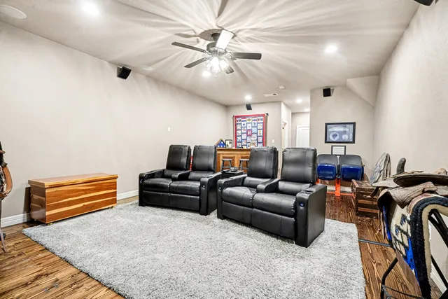 a living room with furniture a ceiling fan and a rug