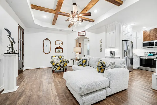 a living room with furniture and wooden floor