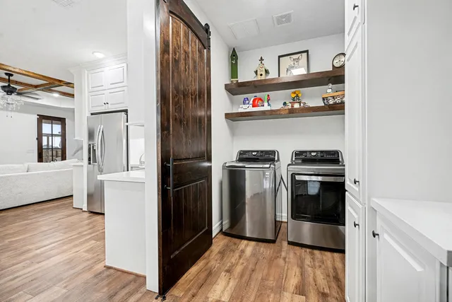 a kitchen with stainless steel appliances granite countertop a refrigerator and a stove