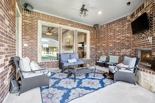 a living room with furniture windows and a flat screen tv