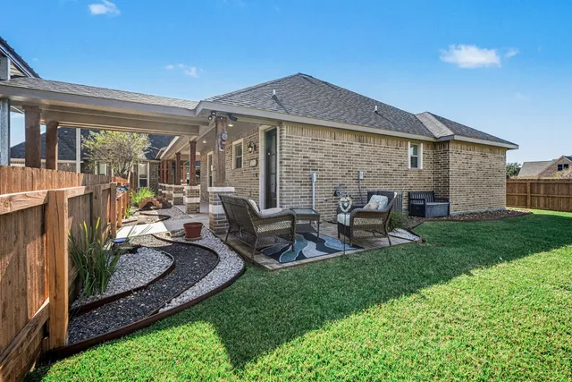 a view of a house with backyard porch and furniture