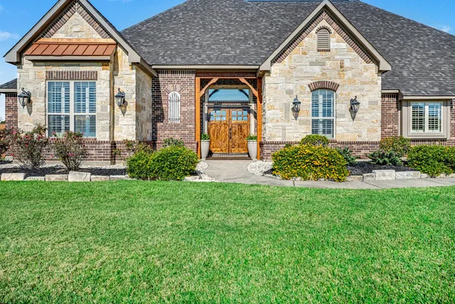 a front view of a house with garden