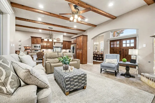 a living room with furniture and a chandelier