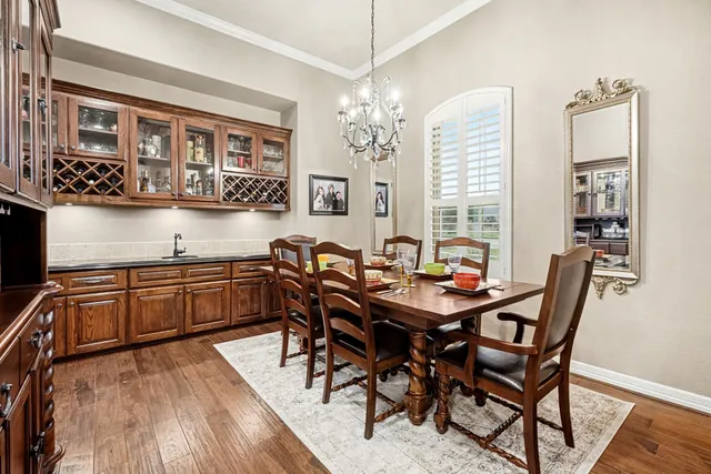 a view of a dining room with furniture and chandelier