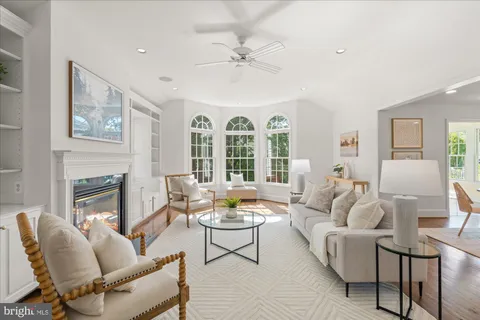 a living room with furniture a fireplace and a large window