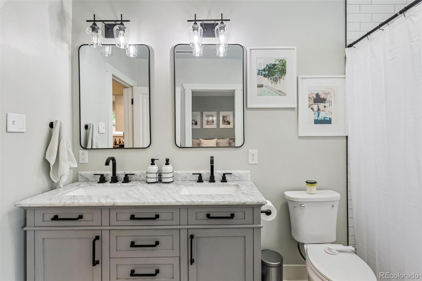3612 Perry Street Denver, CO 80212 - Photo 16 of 50 a bathroom with a granite countertop toilet sink and mirror