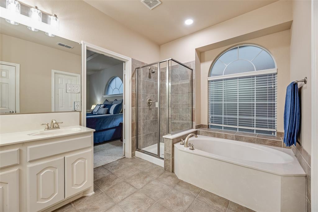 11920 Vienna Apple Road Fort Worth, TX 76244 - Photo 24 of 40 Primary bathroom with ceramic tile floors, separate tub and shower, and walk-in closet at 11920 Vienna Apple in Villages of Woodland Springs community in North Fort Worth
