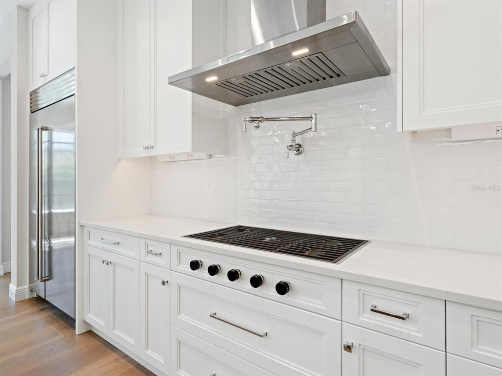 1876 Magnolia Street Sarasota, FL 34239 - Photo 13 of 72 a kitchen with white cabinets and white appliances