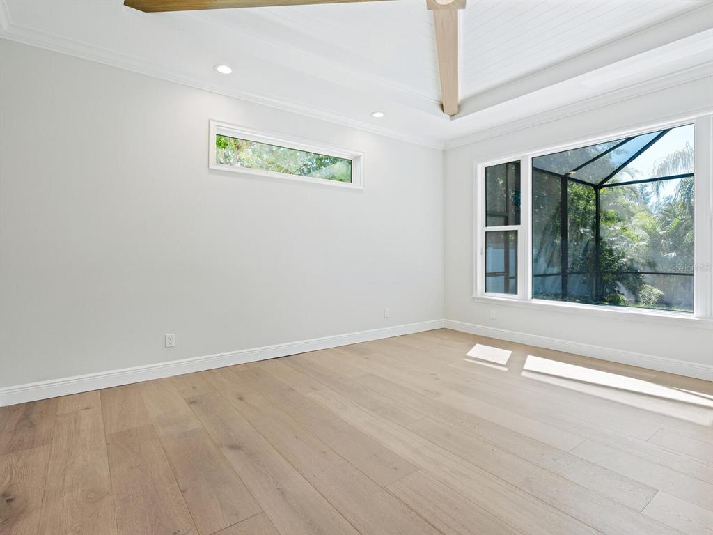 1876 Magnolia Street Sarasota, FL 34239 - Photo 17 of 72 a view of an empty room with wooden floor and a window