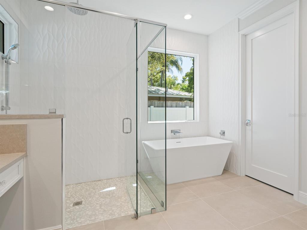 1876 Magnolia Street Sarasota, FL 34239 - Photo 22 of 72 a bathroom with a bathtub and a shower