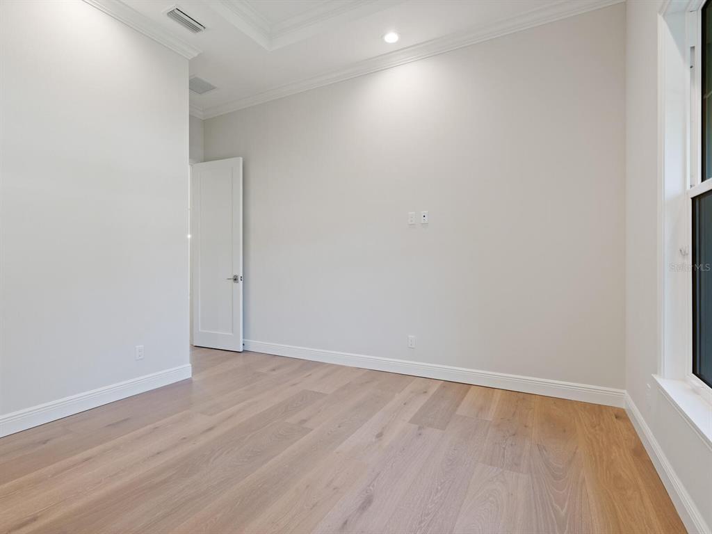 1876 Magnolia Street Sarasota, FL 34239 - Photo 25 of 72 a view of an empty room with wooden floor and a window