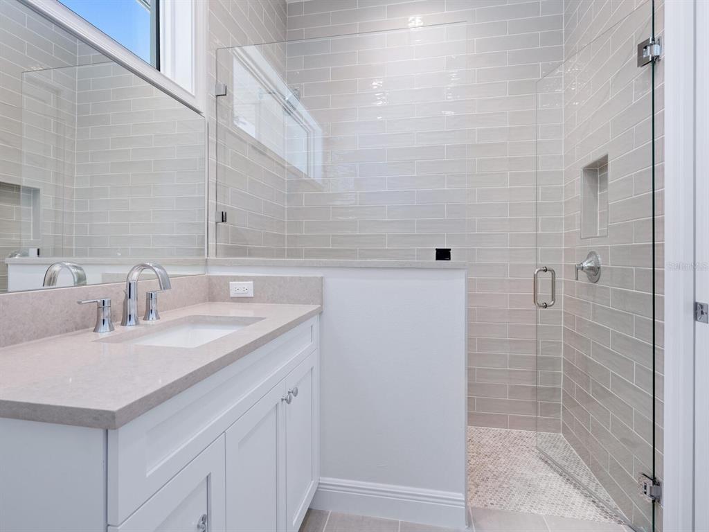 1876 Magnolia Street Sarasota, FL 34239 - Photo 26 of 72 a bathroom with a sink and a mirror