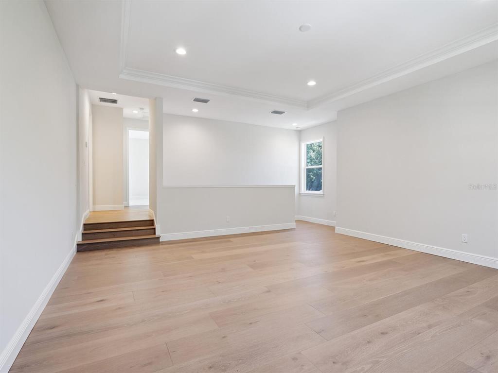 1876 Magnolia Street Sarasota, FL 34239 - Photo 28 of 72 an empty room with wooden floor and windows