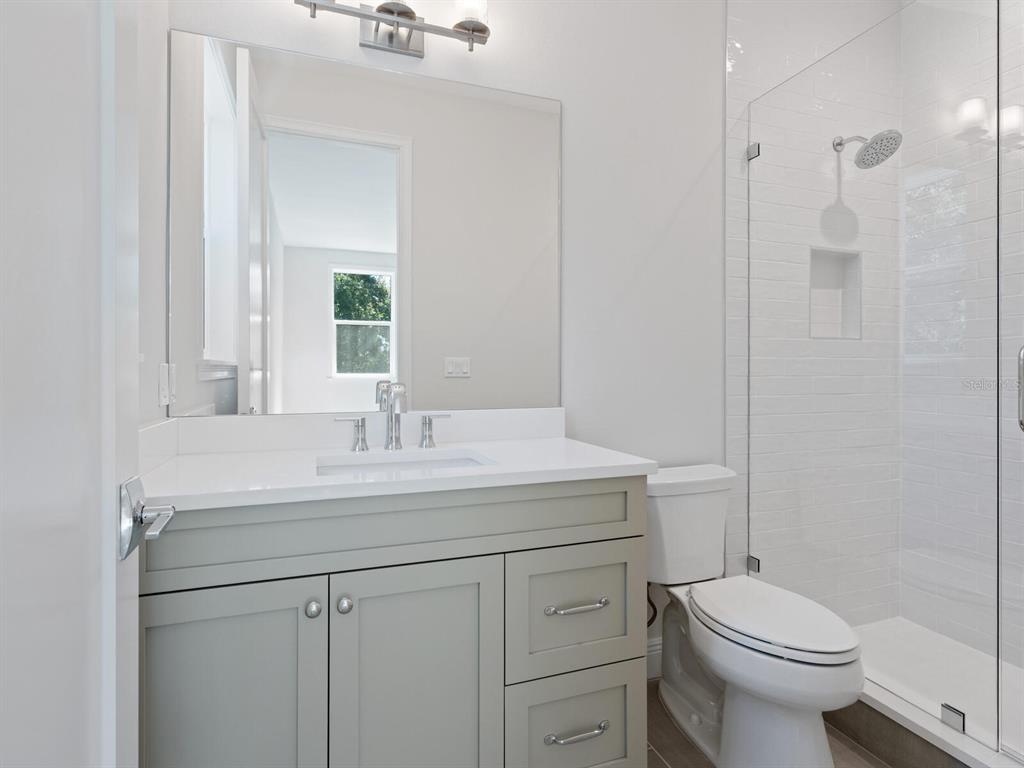 1876 Magnolia Street Sarasota, FL 34239 - Photo 31 of 72 a bathroom with a sink toilet and a mirror
