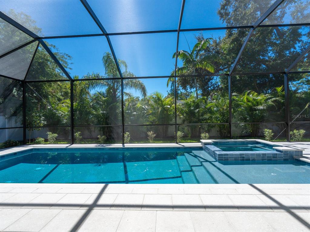 1876 Magnolia Street Sarasota, FL 34239 - Photo 36 of 72 a view of a swimming pool with a patio and plants
