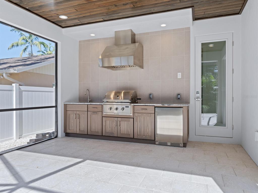 1876 Magnolia Street Sarasota, FL 34239 - Photo 41 of 72 a kitchen with white cabinets and window