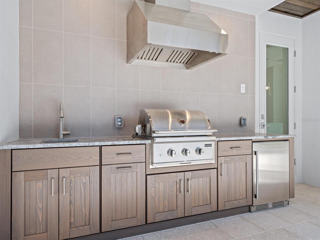 1876 Magnolia Street Sarasota, FL 34239 - Photo 42 of 72 a kitchen with white cabinets and white appliances