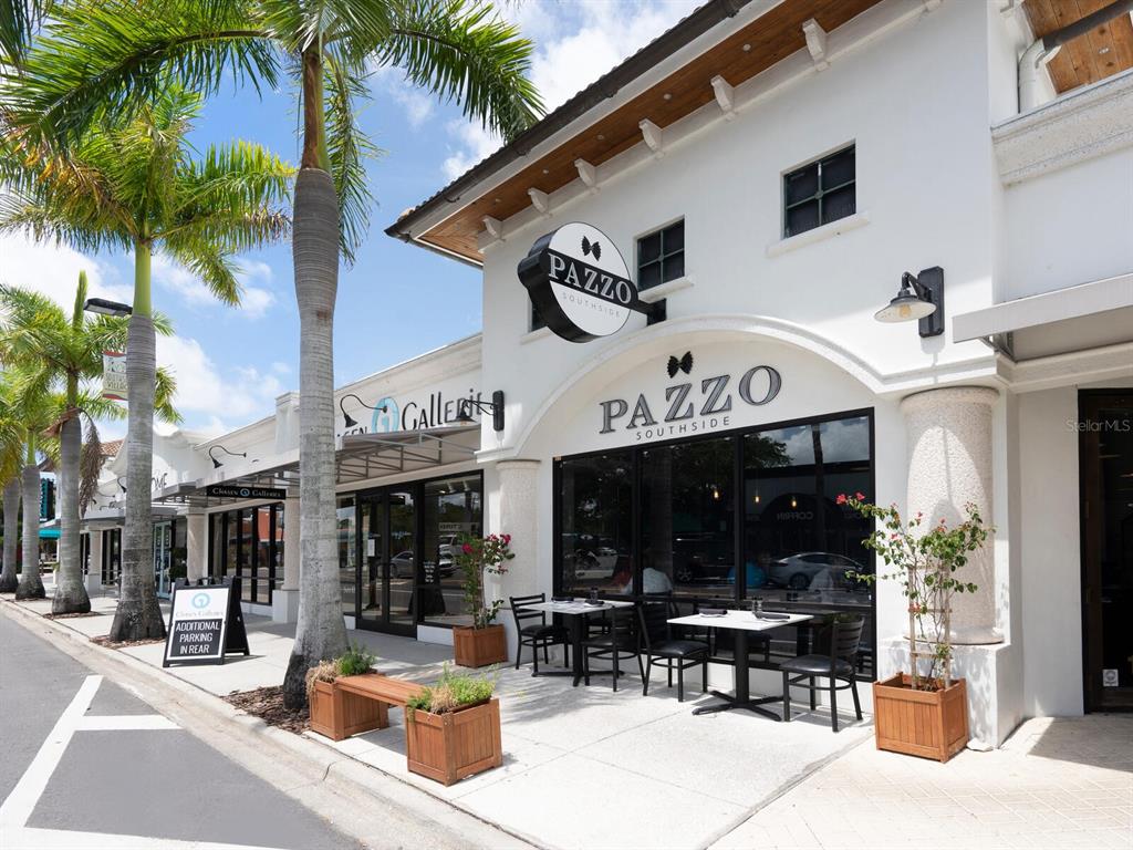 1876 Magnolia Street Sarasota, FL 34239 - Photo 53 of 72 a view of the patio with dining table and chairs under an umbrella