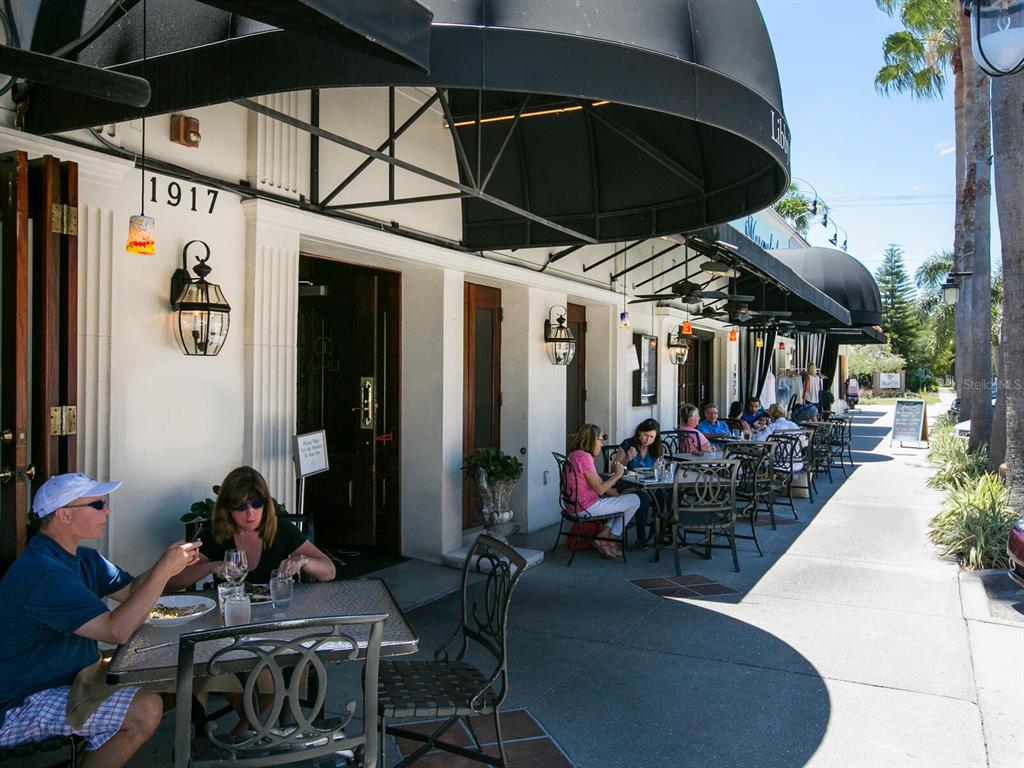 1876 Magnolia Street Sarasota, FL 34239 - Photo 55 of 72 a view of a patio with table and chairs under an umbrella
