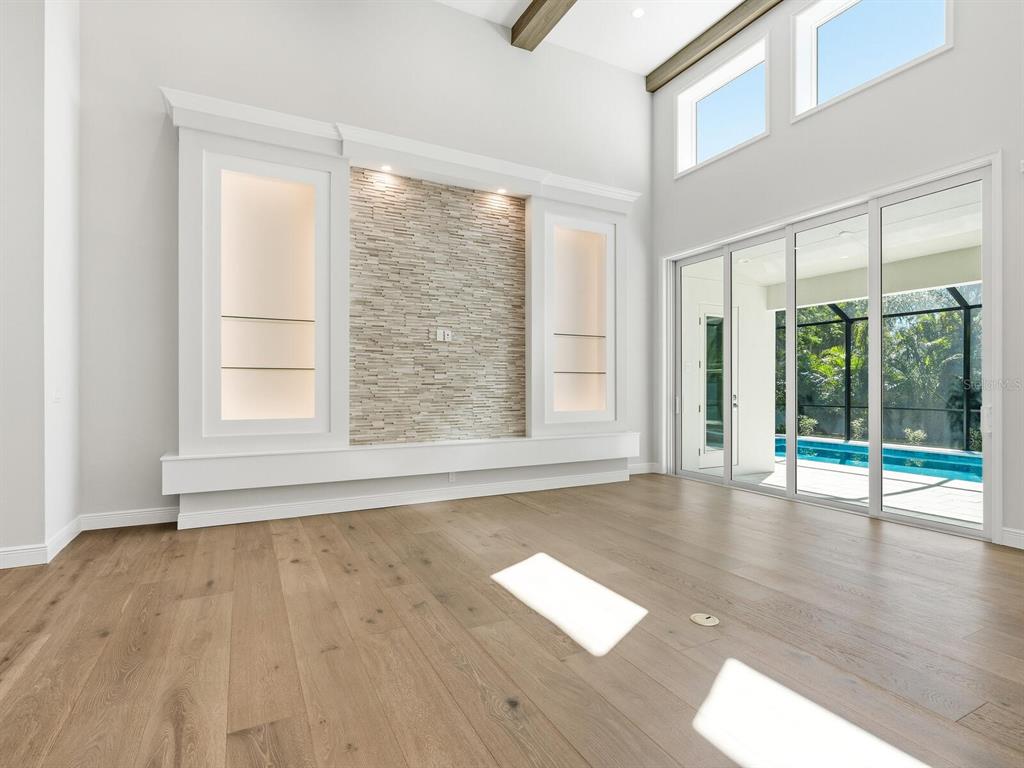 1876 Magnolia Street Sarasota, FL 34239 - Photo 8 of 72 a view of an empty room with wooden floor and a window