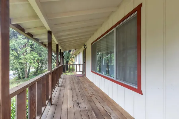 a view of a balcony with wooden floor