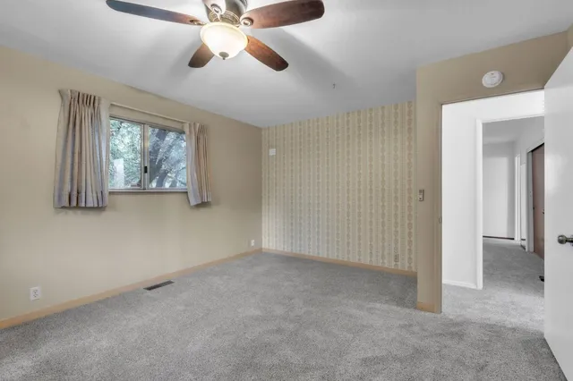 a view of an empty room with a window